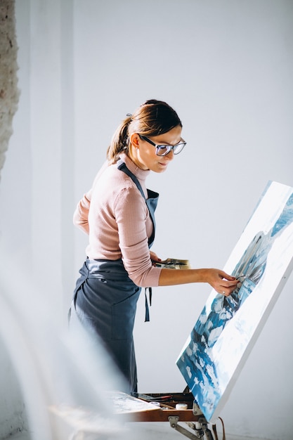 Free photo female artist painting in studio