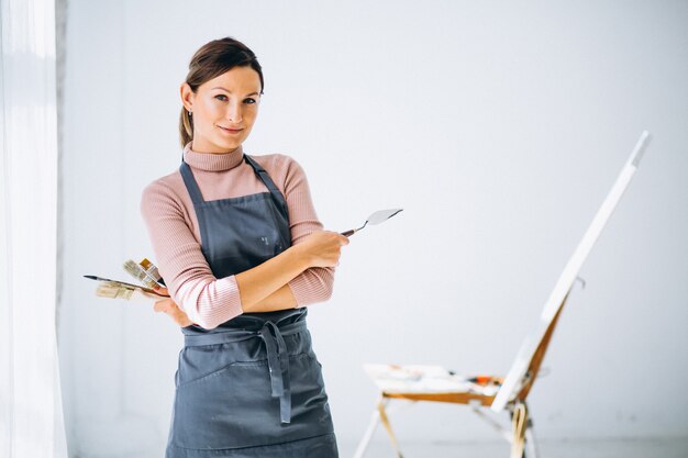 Female artist painting in studio