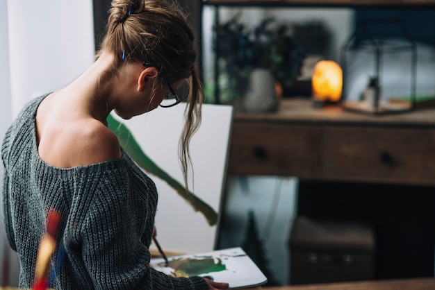 Female artist painting in studio