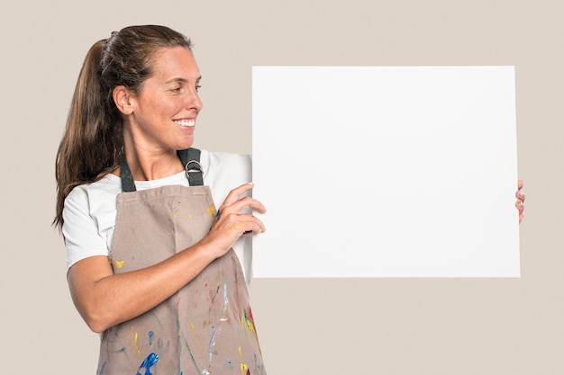 Female artist showing a white canvas with design space