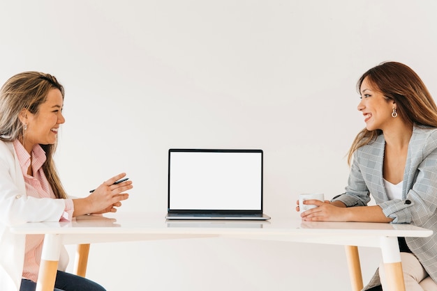 Free photo female asian coworkers cooperating at office