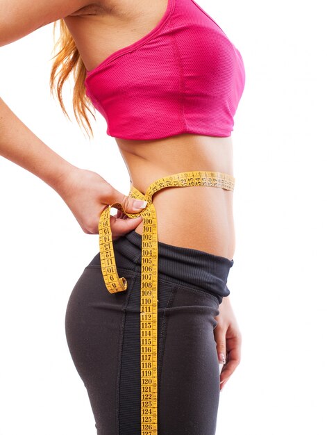 Female athlete being measured waist