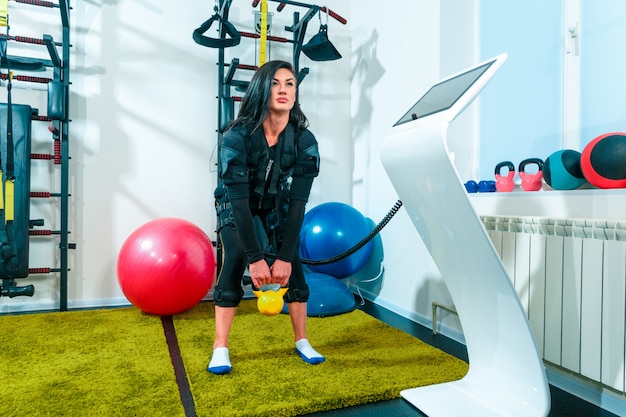 Female athlete doing exercises in a fitness studio