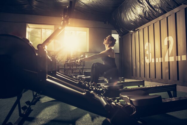 The female athlete training hard in the gym.