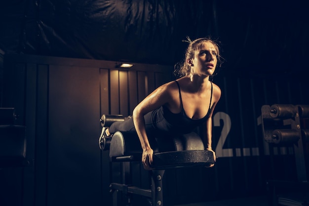 The female athlete training hard in the gym.