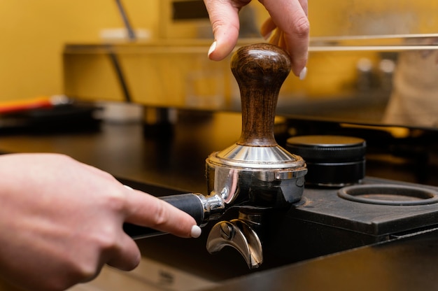 Female barista using professional coffee cup