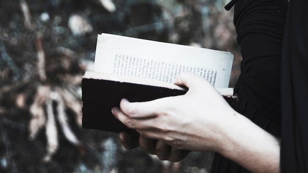 Female in black with opened book