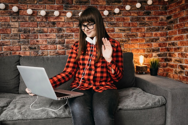 Female blogger streaming online with laptop