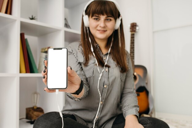 Female blogger streaming with smartphone and headphones