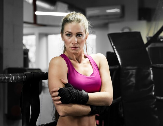 Female boxer posing in training center