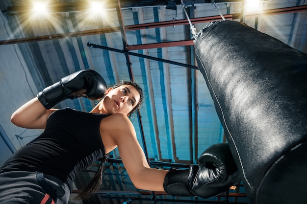 Free photo the female boxer training at gym