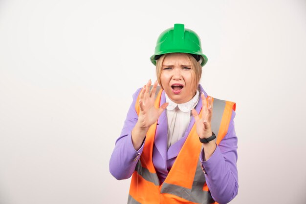 Female builder in helmet on white background. High quality photo