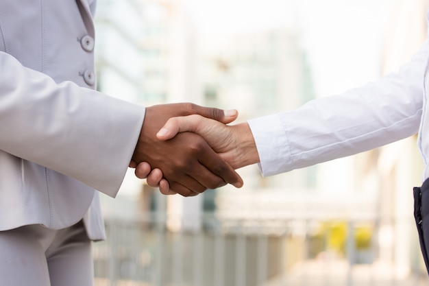 Female business colleagues shaking hands