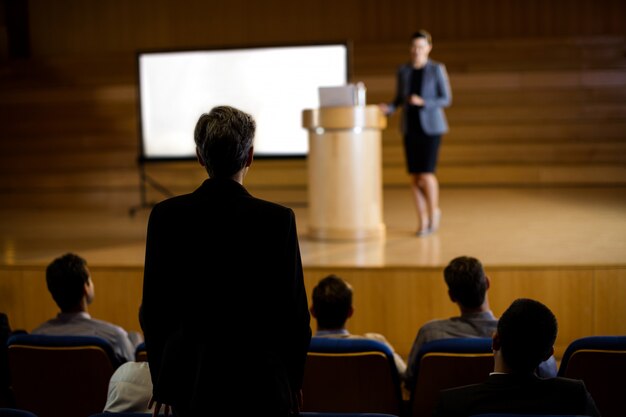 Female business executive giving a speech