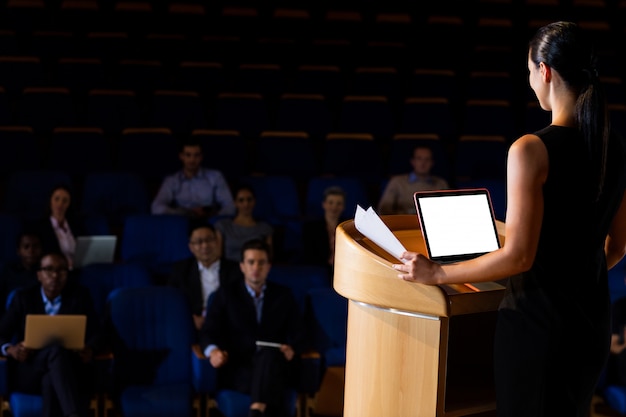 Female business executive giving a speech