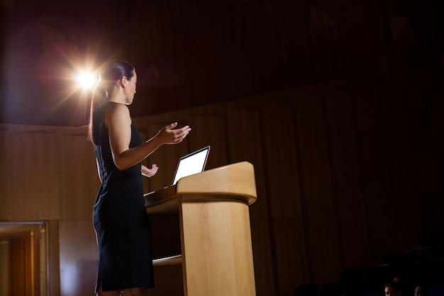 Female business executive giving a speech