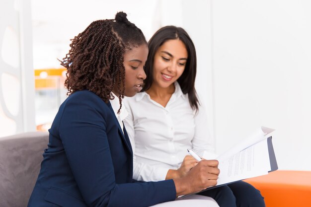 Female business partners signing agreement