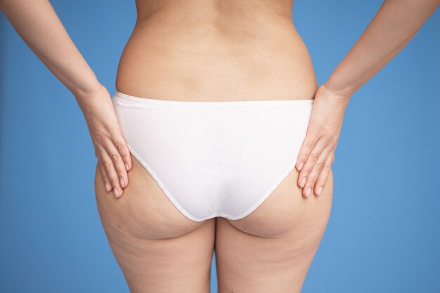 Premium Photo Female Buttocks In Light Underwear On A Blue