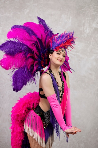 Female cabaret performer posing in feathers costume