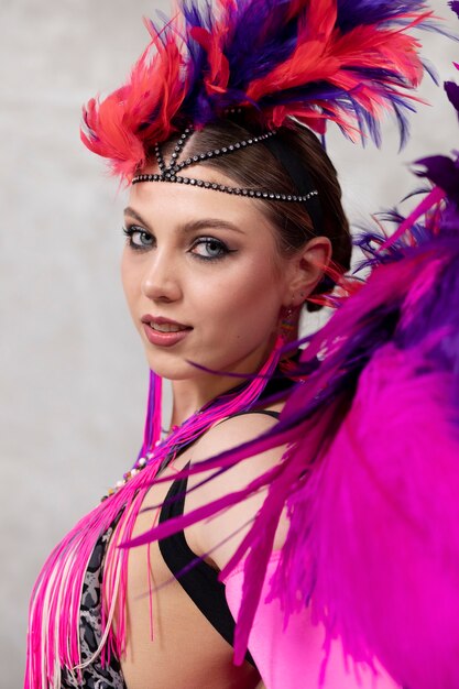 Female cabaret performer posing in feathers costume