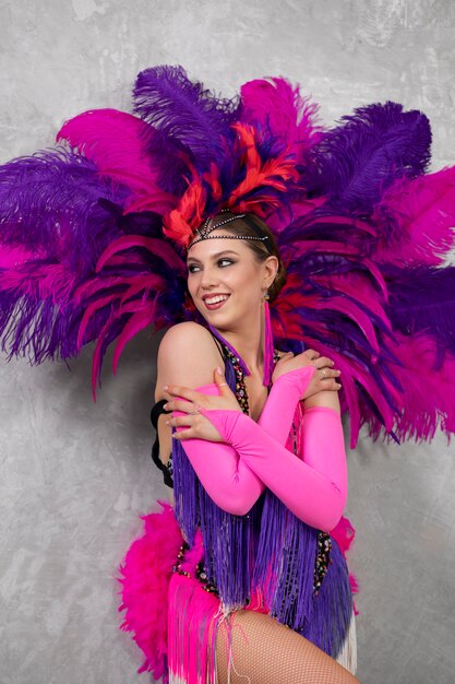 Female cabaret performer posing in feathers costume