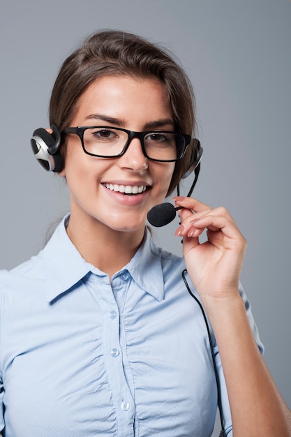 Female call center agent posing with headphones with mic