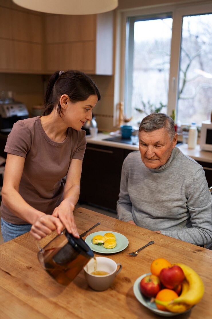 Free Photo female caretaker with client at home doing her job