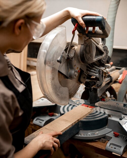 Female carpenter with tool and glasses