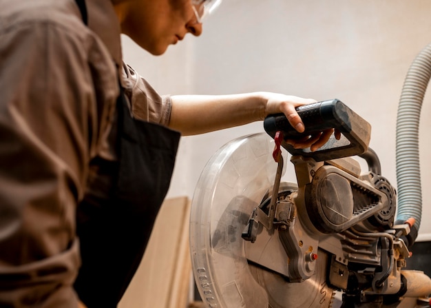 Free photo female carpenter with tool in the studio