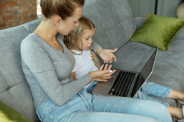 Female caucasian teacher and little girl, or mom and daughter.