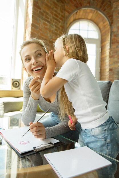 Female caucasian teacher and little girl, or mom and daughter.