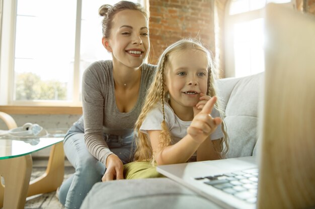 Female caucasian teacher and little girl, or mom and daughter.