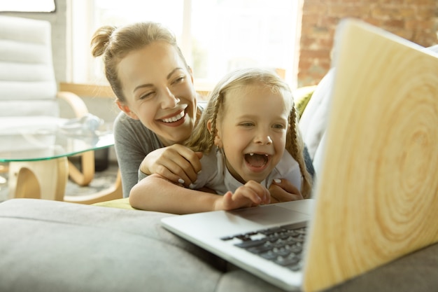 Female caucasian teacher and little girl, or mom and daughter.