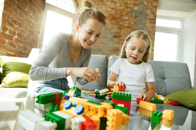 Female caucasian teacher and little girl, or mom and daughter.