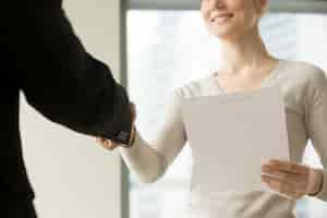 Free photo female ceo congratulating partner with good deal