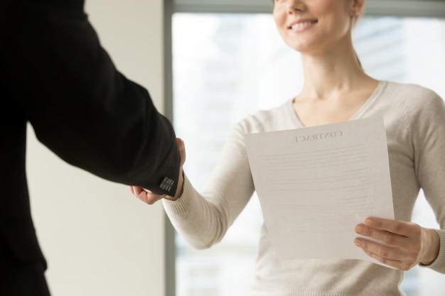 Female CEO congratulating partner with good deal