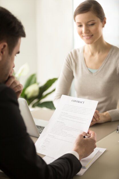 Female CEO waiting until partner reading contract