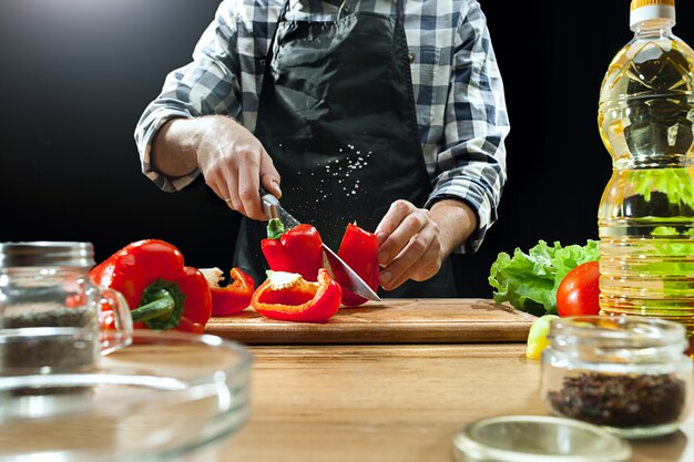 Female chef cutting fresh vegetables