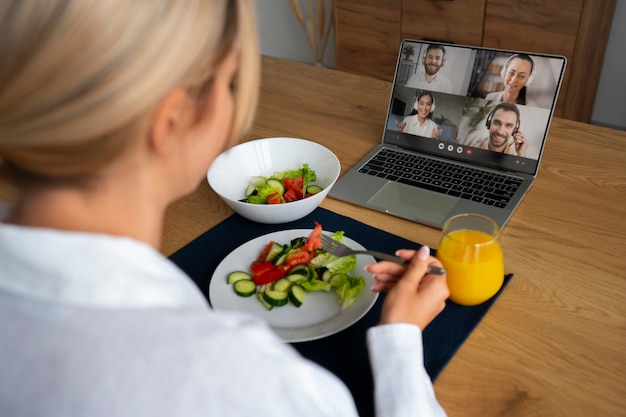 Foto gratuita cuoco unico femminile che ha una videochiamata mentre cucina