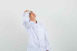 Free photo female chef holding hand on forehead in white uniform and looking dreamy