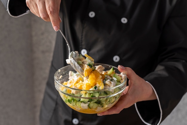 Female chef mixing ingredients in bowl