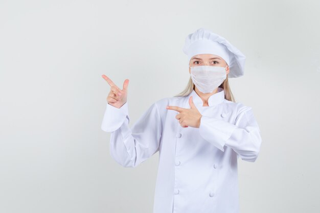 Female chef pointing to side with gun gesture in white uniform