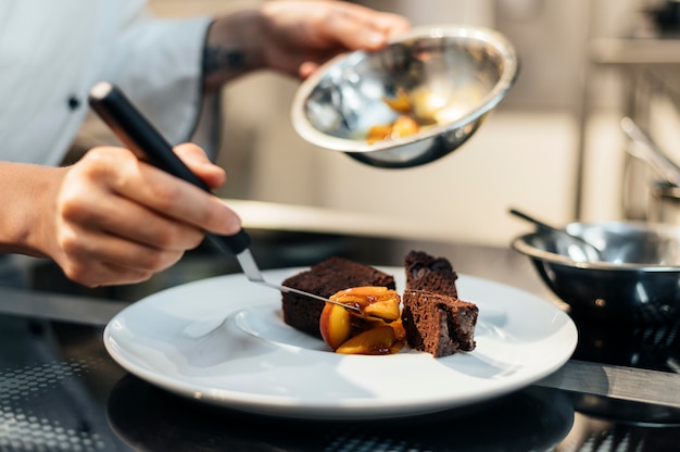 Female chef preparing dish