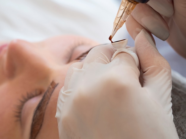 Female client going through a microblading treatment