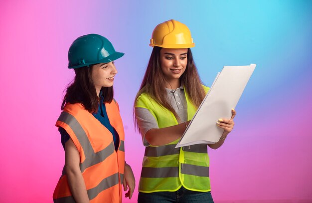 Female construction engineers working together and discussing the project plan