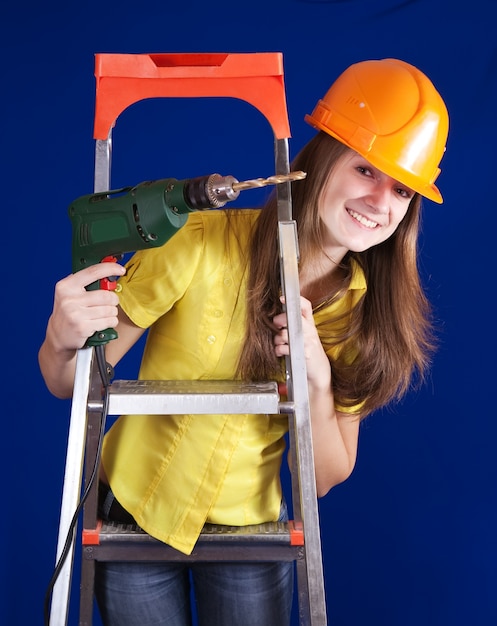 Free photo female construction worker with drill