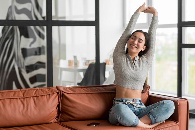 Female on couch stretching