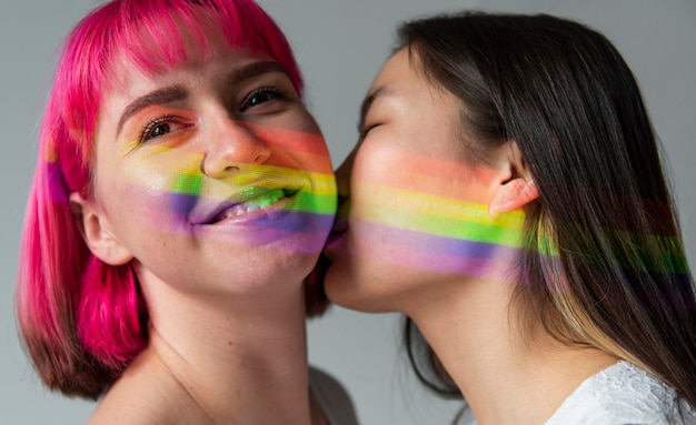 Free photo female couple with rainbow symbol