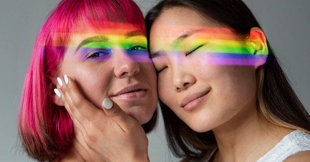 Free photo female couple with rainbow symbol