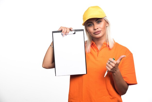 Female courier holding empty notebook on white background showing thumbs up. High quality photo